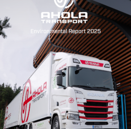 Electric truck charging at a charging station in Naantali with the text Ahola Transport Environmental report 2025 superimposed over the image